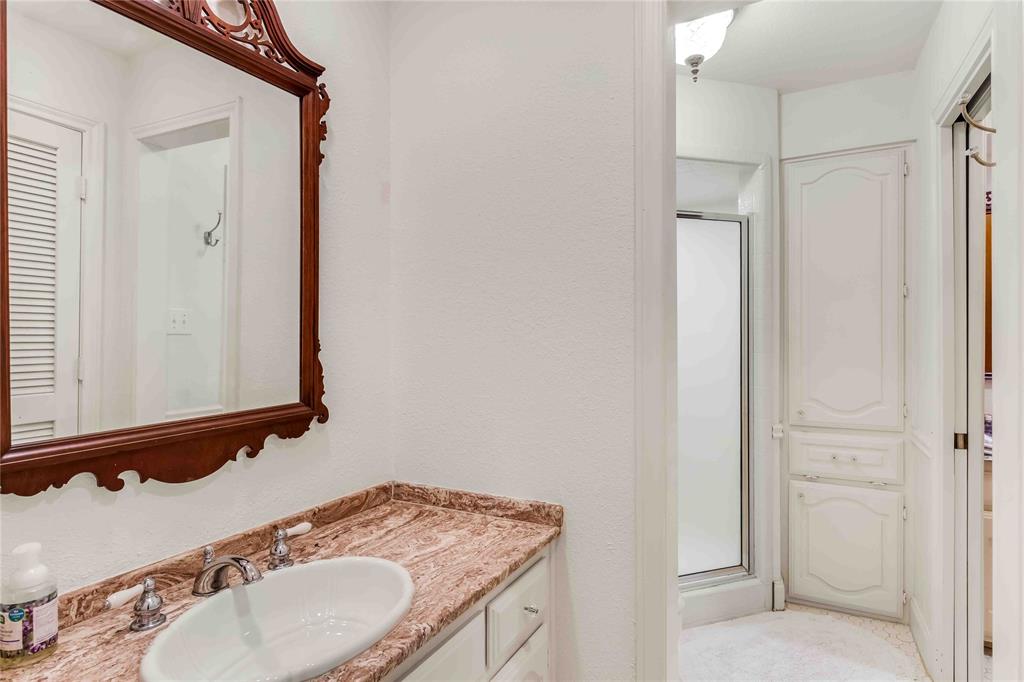 216 McMillen Road Lucas, TX 75002 - Photo 22 of 36 a bathroom with a granite countertop sink and a mirror