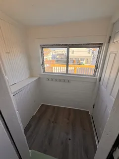 a view of wooden floor and windows in a room