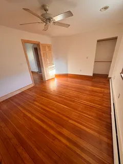 a view of a room with wooden floor