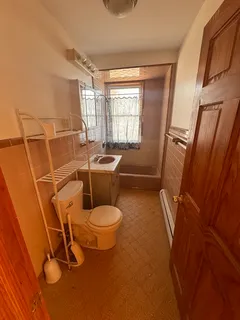 a bathroom with a toilet sink and tub