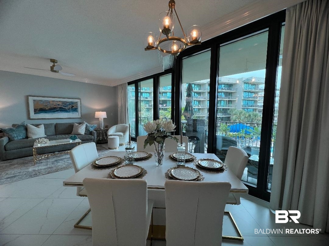 27580 Canal Road, Unit 1210 Orange Beach, AL 36561 - Photo 8 of 28 Dining area with a chandelier, floor to ceiling windows, a textured ceiling, and ornamental molding