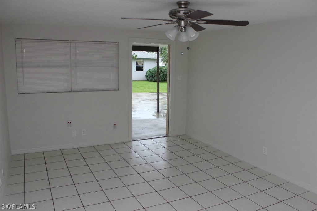 112 Florida Road Lehigh Acres, FL 33936 - Photo 11 of 25 a view of an empty room and chandelier fan
