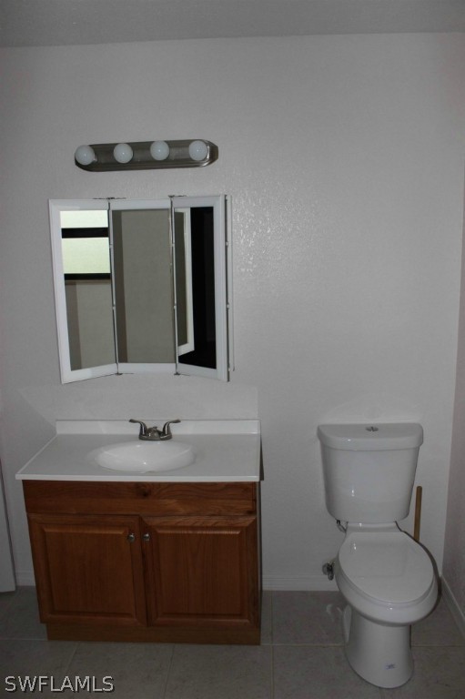 112 Florida Road Lehigh Acres, FL 33936 - Photo 15 of 25 a bathroom with a toilet sink and mirror