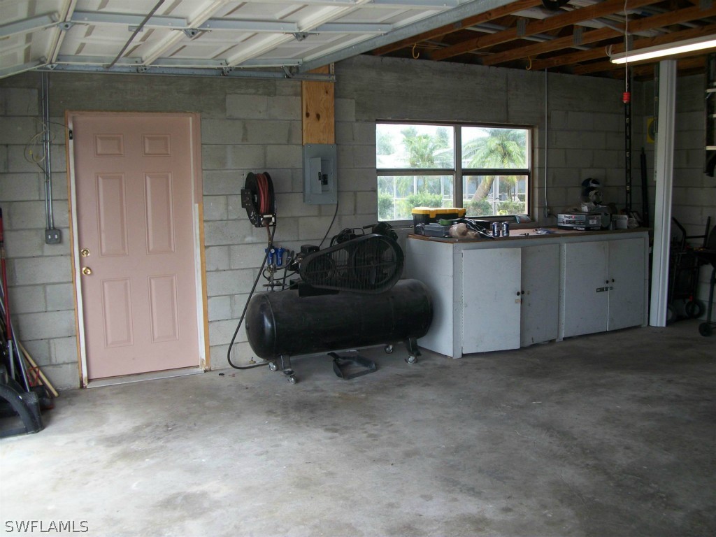 112 Florida Road Lehigh Acres, FL 33936 - Photo 23 of 25 a living room with a couch and a table