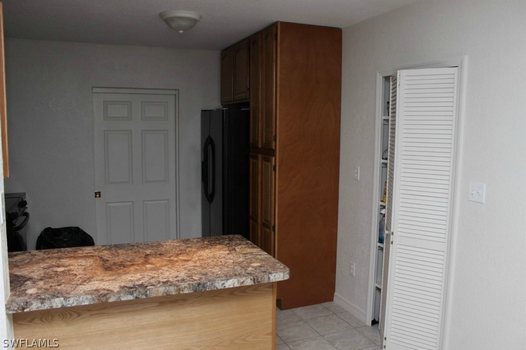 112 Florida Road Lehigh Acres, FL 33936 - Photo 4 of 25 a bedroom with a bed and a closet