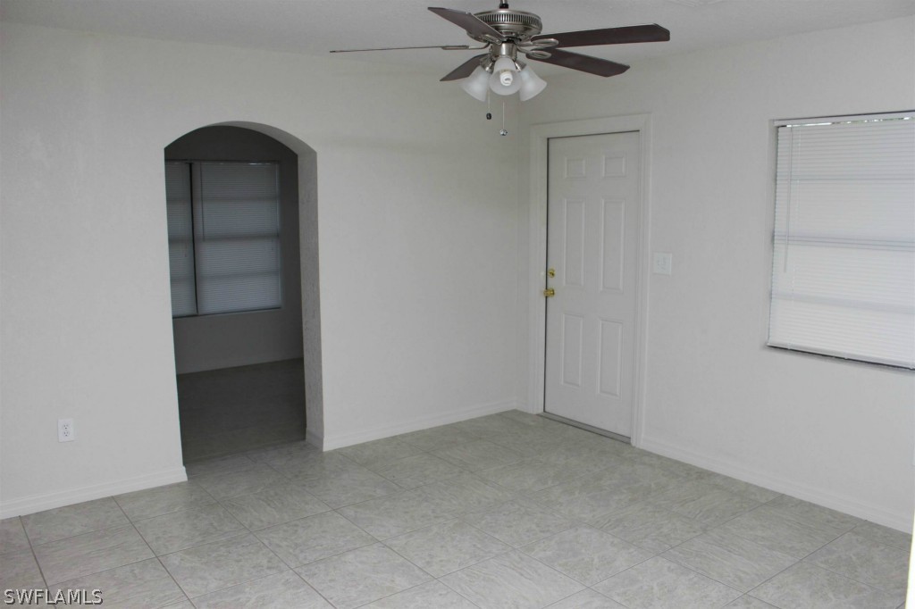 112 Florida Road Lehigh Acres, FL 33936 - Photo 6 of 25 a view of an empty room with a fan