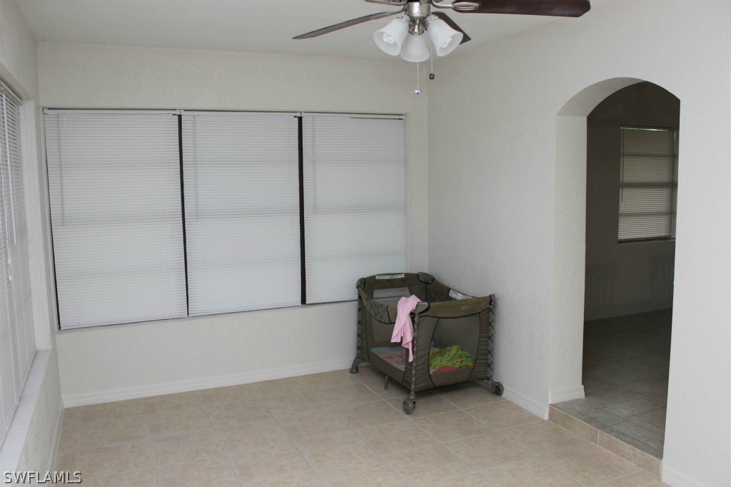 112 Florida Road Lehigh Acres, FL 33936 - Photo 9 of 25 a bedroom with a bed and chandelier