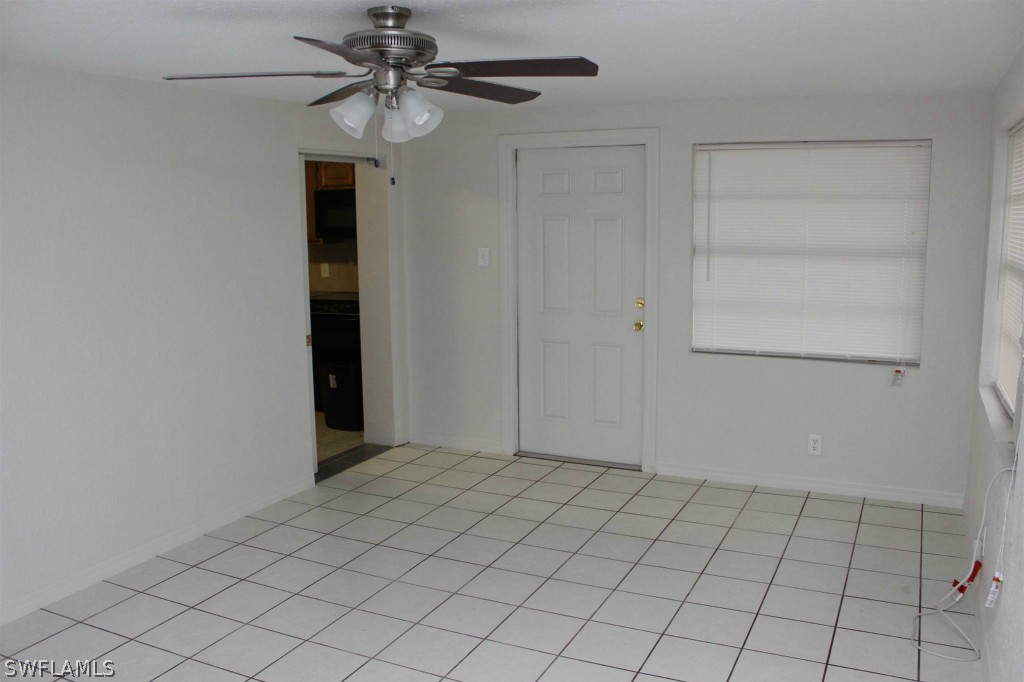 112 Florida Road Lehigh Acres, FL 33936 - Photo 10 of 25 an empty room with windows and fan