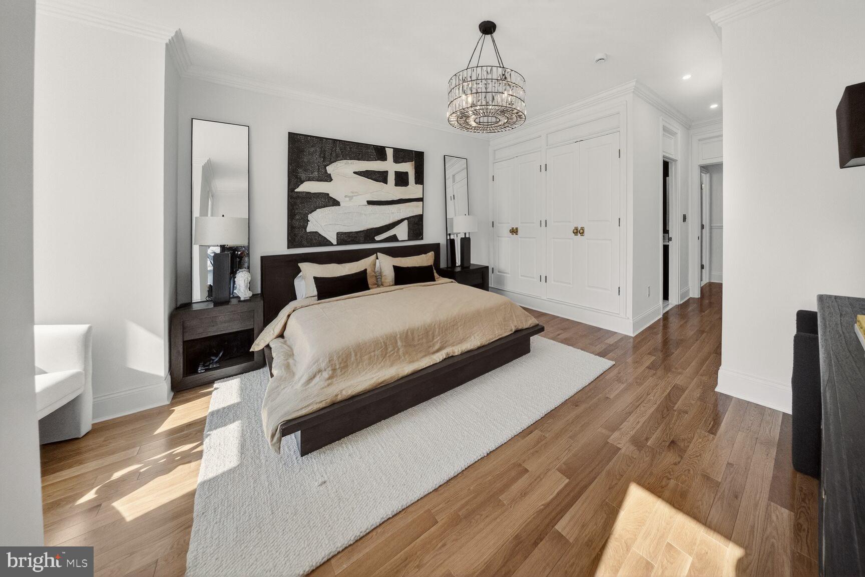 1203 T Street Northwest Washington, DC 20009 - Photo 26 of 46 a bedroom with a bed and a chandelier