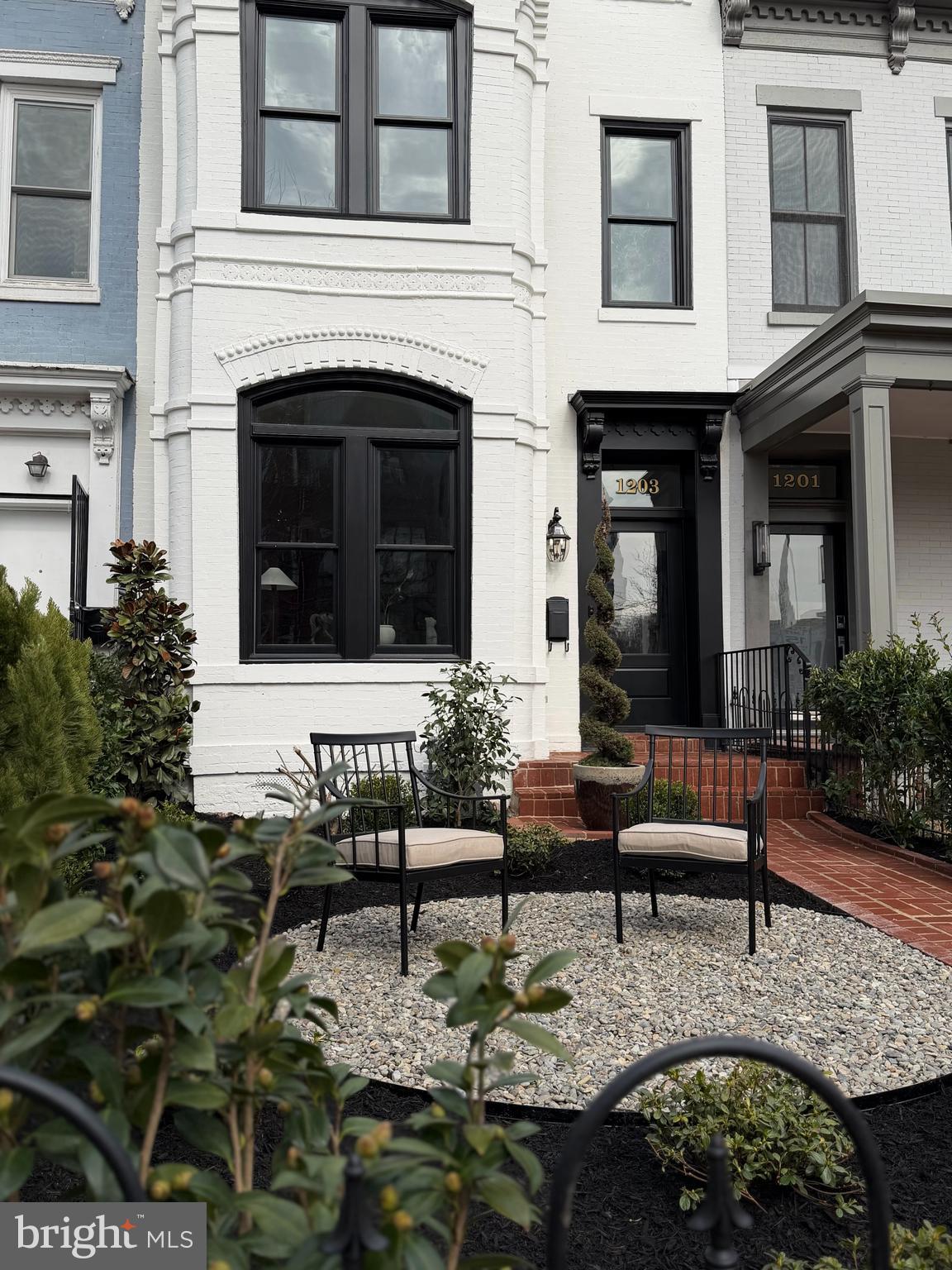 1203 T Street Northwest Washington, DC 20009 - Photo 3 of 46 a view of a patio with couches table and chairs and potted plants