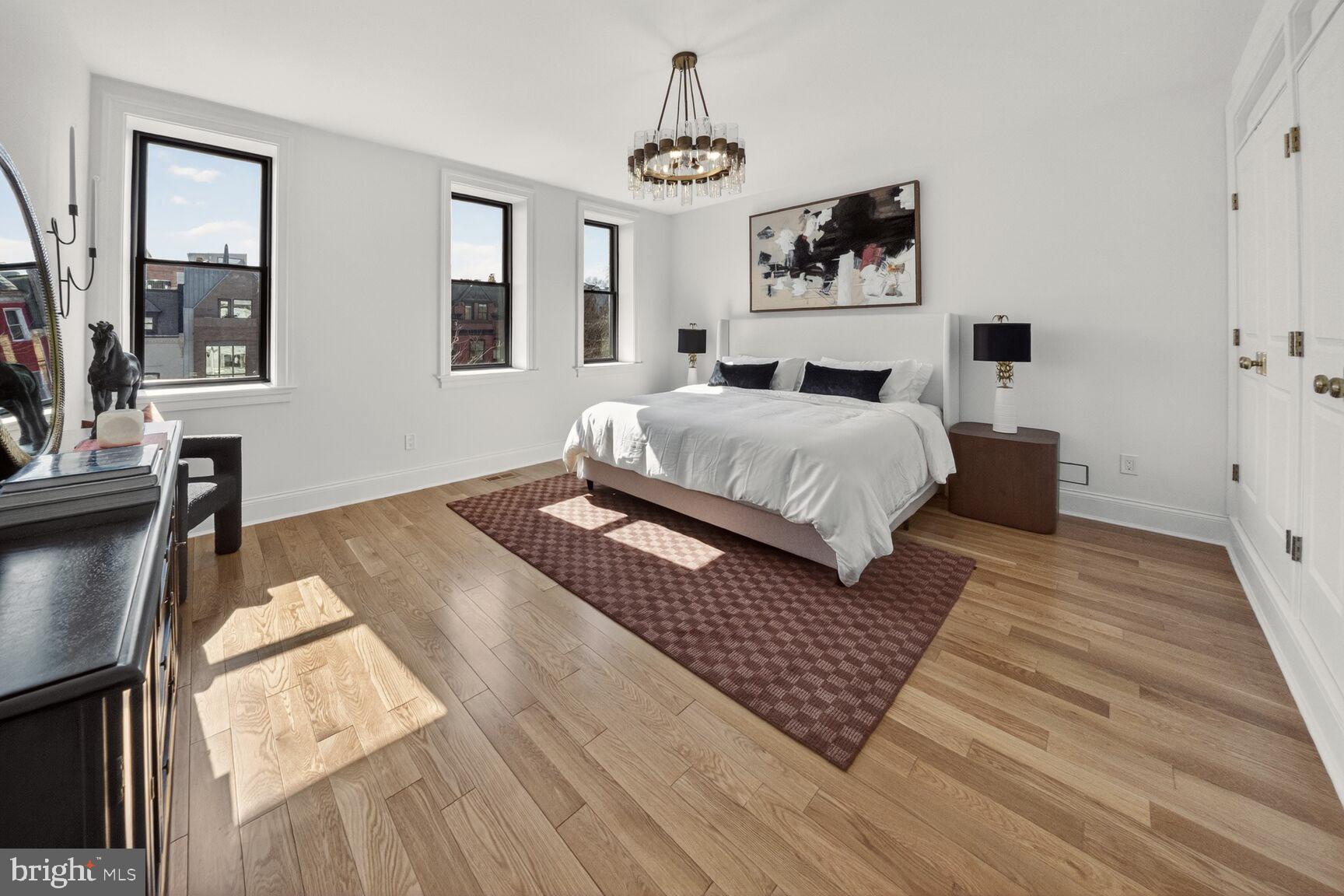 1203 T Street Northwest Washington, DC 20009 - Photo 40 of 46 a bedroom with a bed wooden floor and window