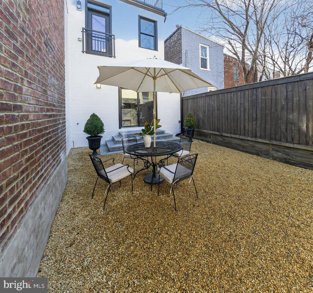 1203 T Street Northwest Washington, DC 20009 - Photo 45 of 46 a backyard of a house with table and chairs