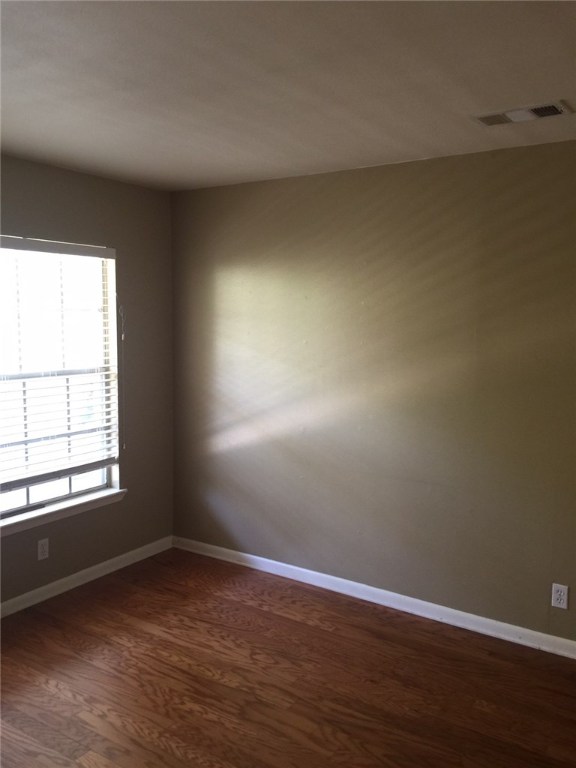 2516 Enfield Road, Unit 201 Austin, TX 78703 - Photo 7 of 11 an empty room with wooden floor and windows