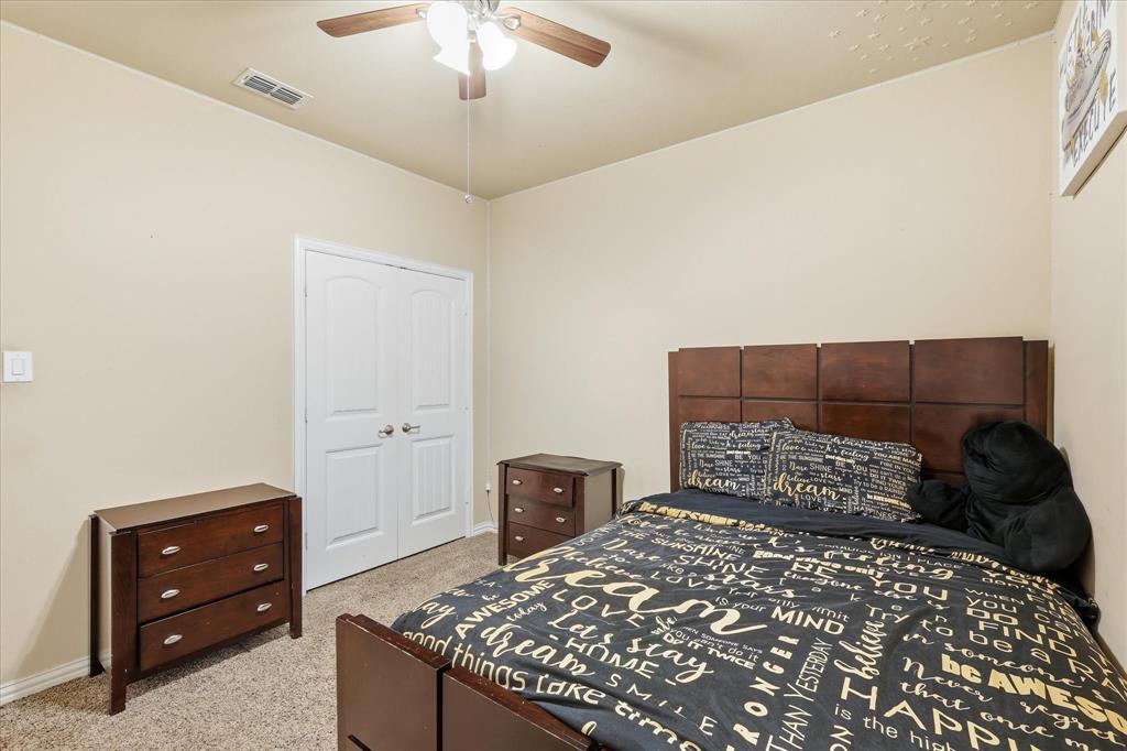 215 Equestrian Road Hickory Creek, TX 75065 - Photo 23 of 36 a bedroom with a bed and a dresser