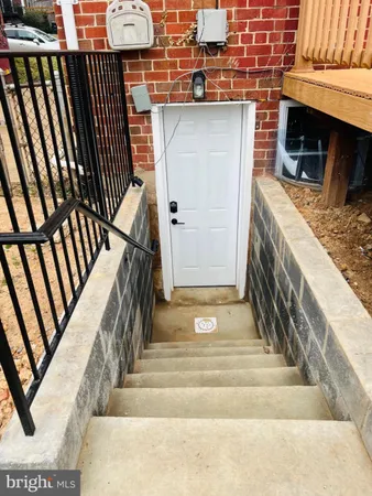 a view of an entryway with wooden floor and door
