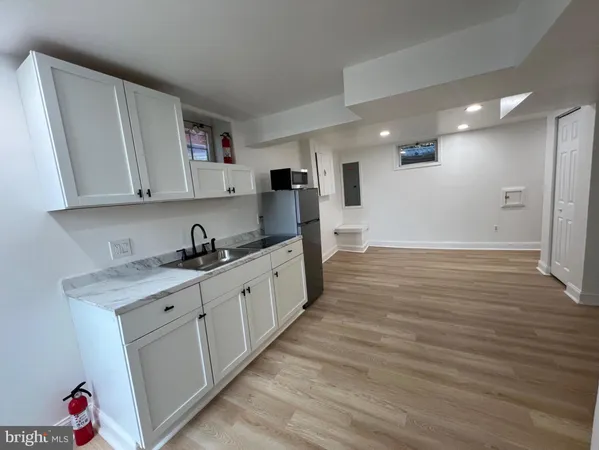 a kitchen with granite countertop a sink and cabinets