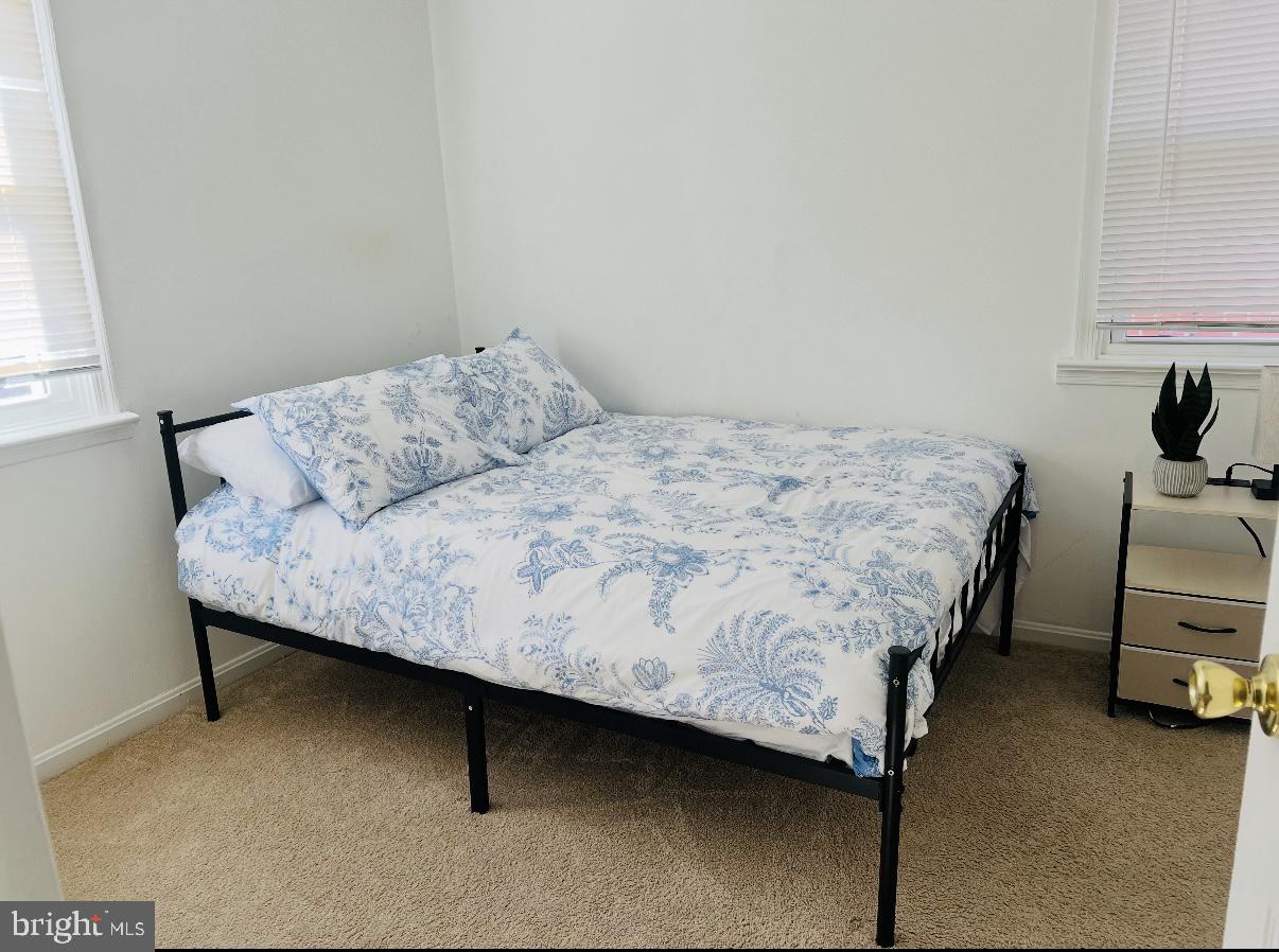 313 Nicholson Street Northeast Washington, DC 20011 - Photo 6 of 12 a bedroom with a bed chair and a window