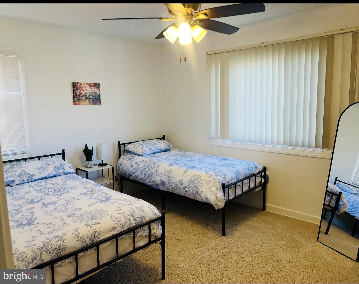 313 Nicholson Street Northeast Washington, DC 20011 - Photo 10 of 12 a bedroom with two beds and a chandelier