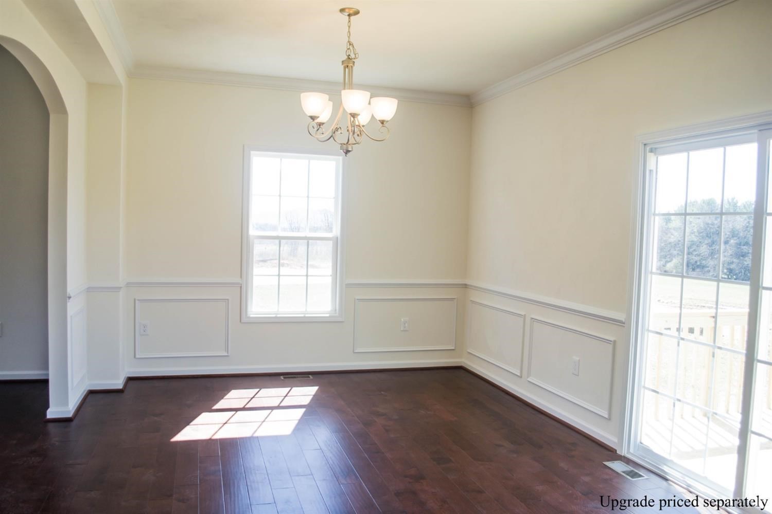 291 Crystal Lane Evington, VA 24550 - Photo 14 of 16 a view of an empty room with wooden floor and a window