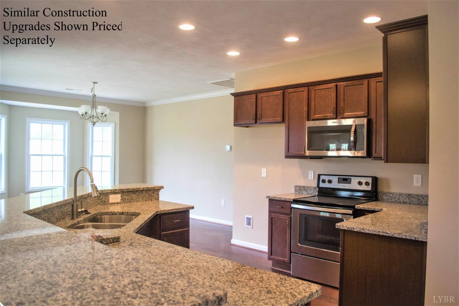 291 Crystal Lane Evington, VA 24550 - Photo 2 of 16 a kitchen with stainless steel appliances granite countertop a sink stove and refrigerator