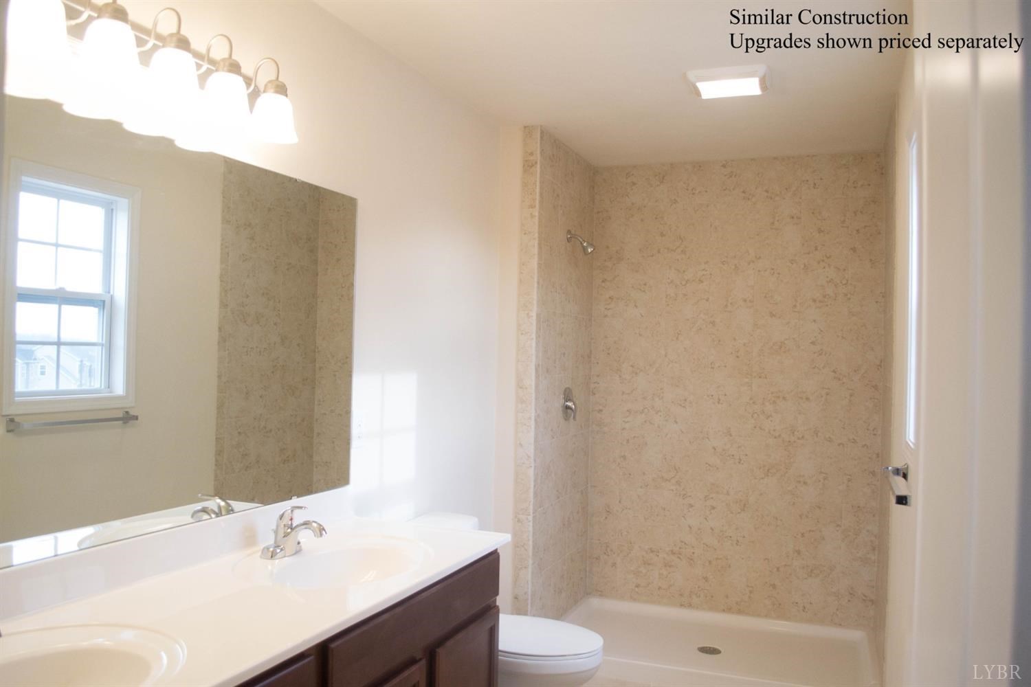 291 Crystal Lane Evington, VA 24550 - Photo 4 of 16 a bathroom with a sink a toilet and shower