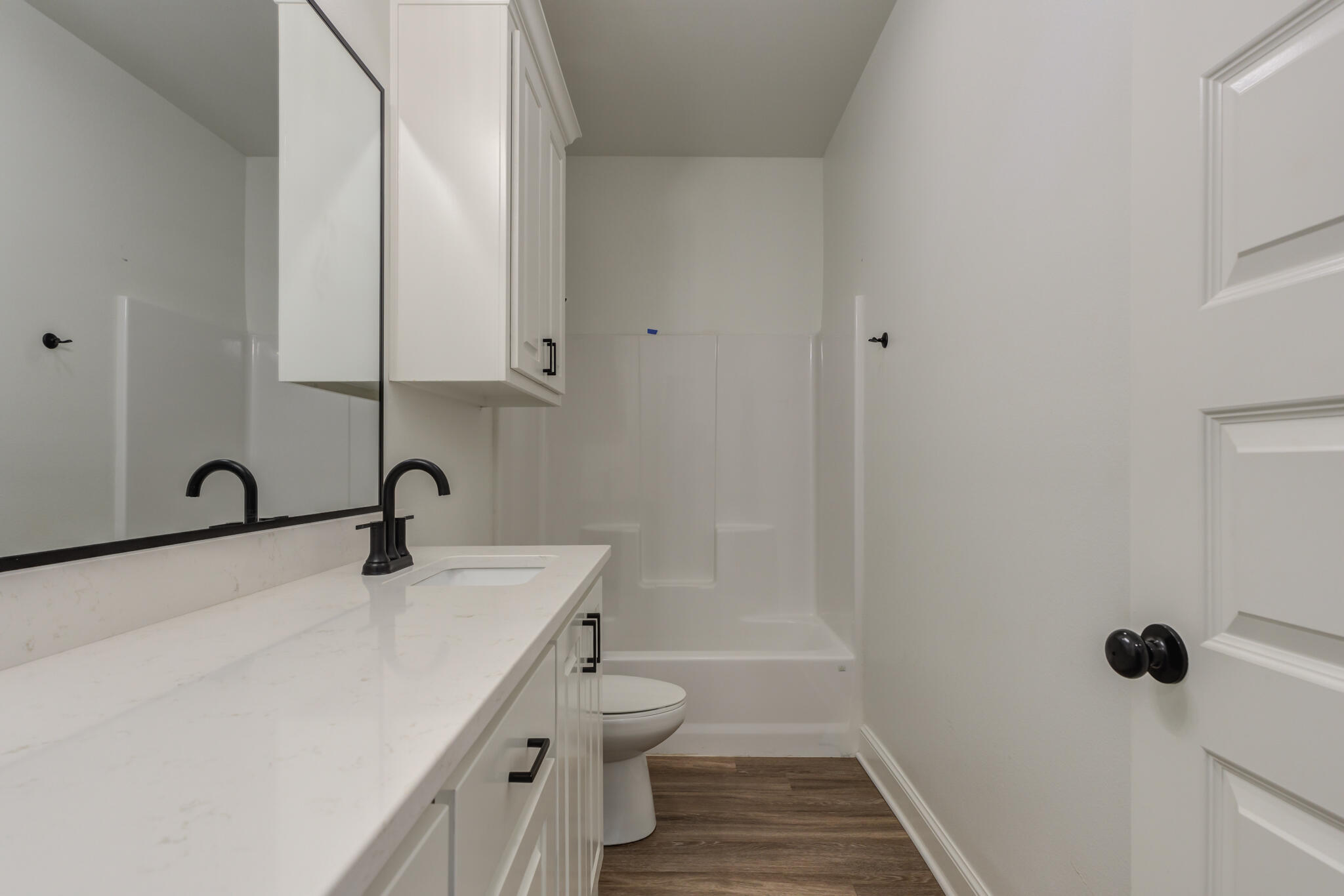 5720 119th Street Lubbock, TX 79424 - Photo 13 of 43 a bathroom with a sink a toilet and shower