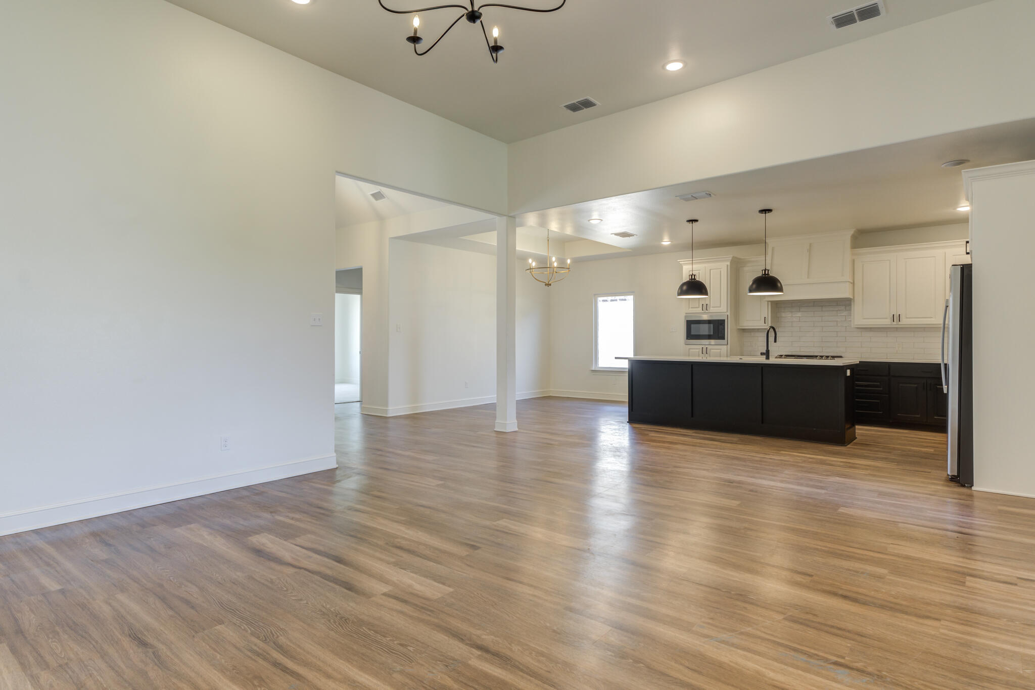 5720 119th Street Lubbock, TX 79424 - Photo 17 of 43 a view of kitchen and hall with wooden floor