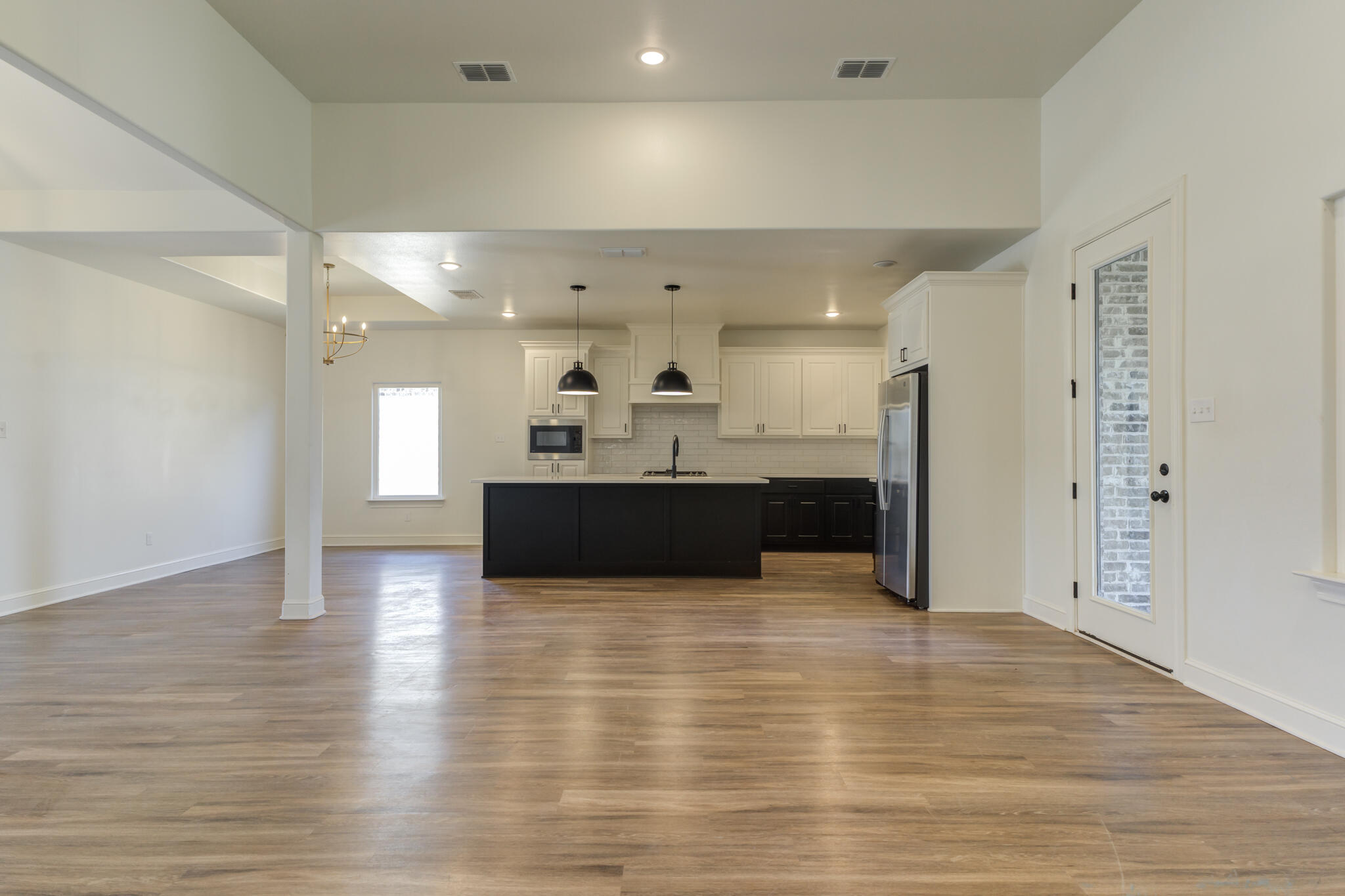 5720 119th Street Lubbock, TX 79424 - Photo 18 of 43 a view of kitchen and hall with wooden floor