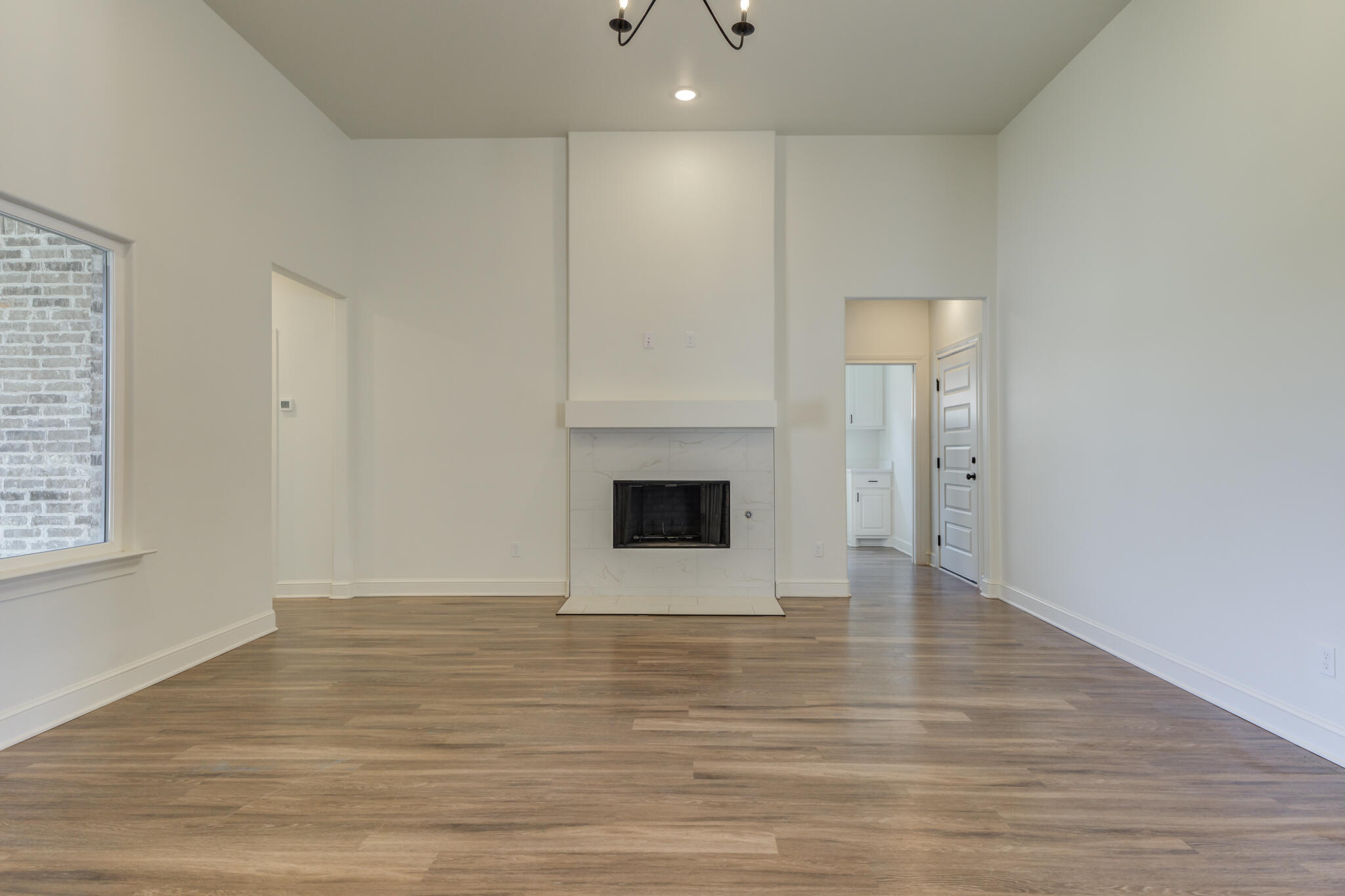 5720 119th Street Lubbock, TX 79424 - Photo 21 of 43 a view of an empty room with wooden floor and a window