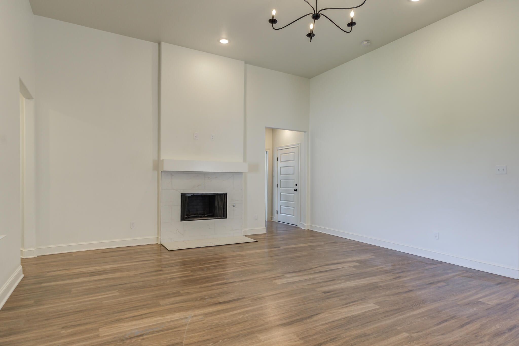 5720 119th Street Lubbock, TX 79424 - Photo 22 of 43 wooden floor in an empty room with a fireplace