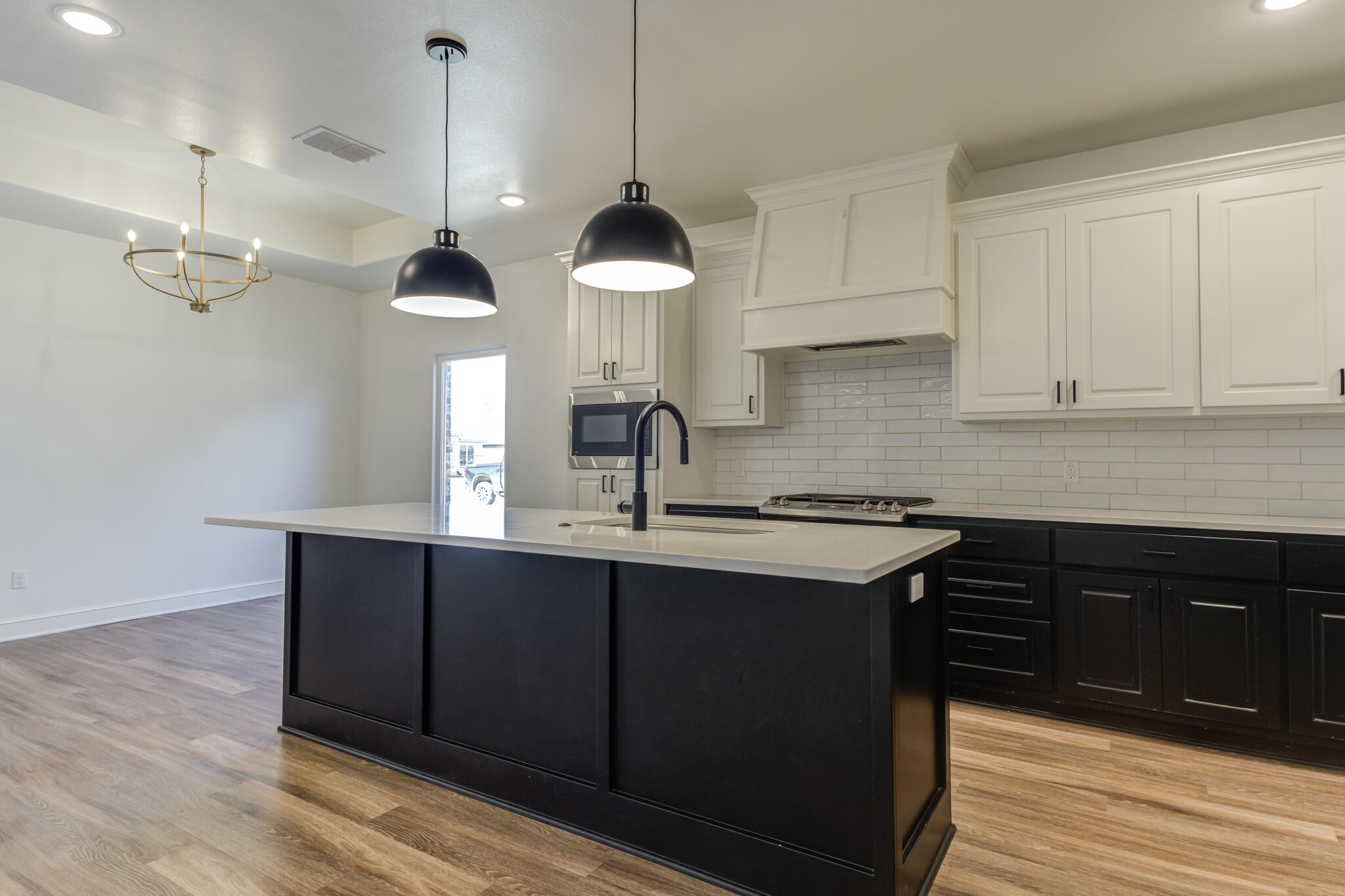 5720 119th Street Lubbock, TX 79424 - Photo 23 of 43 a kitchen with a sink cabinets and wooden floor