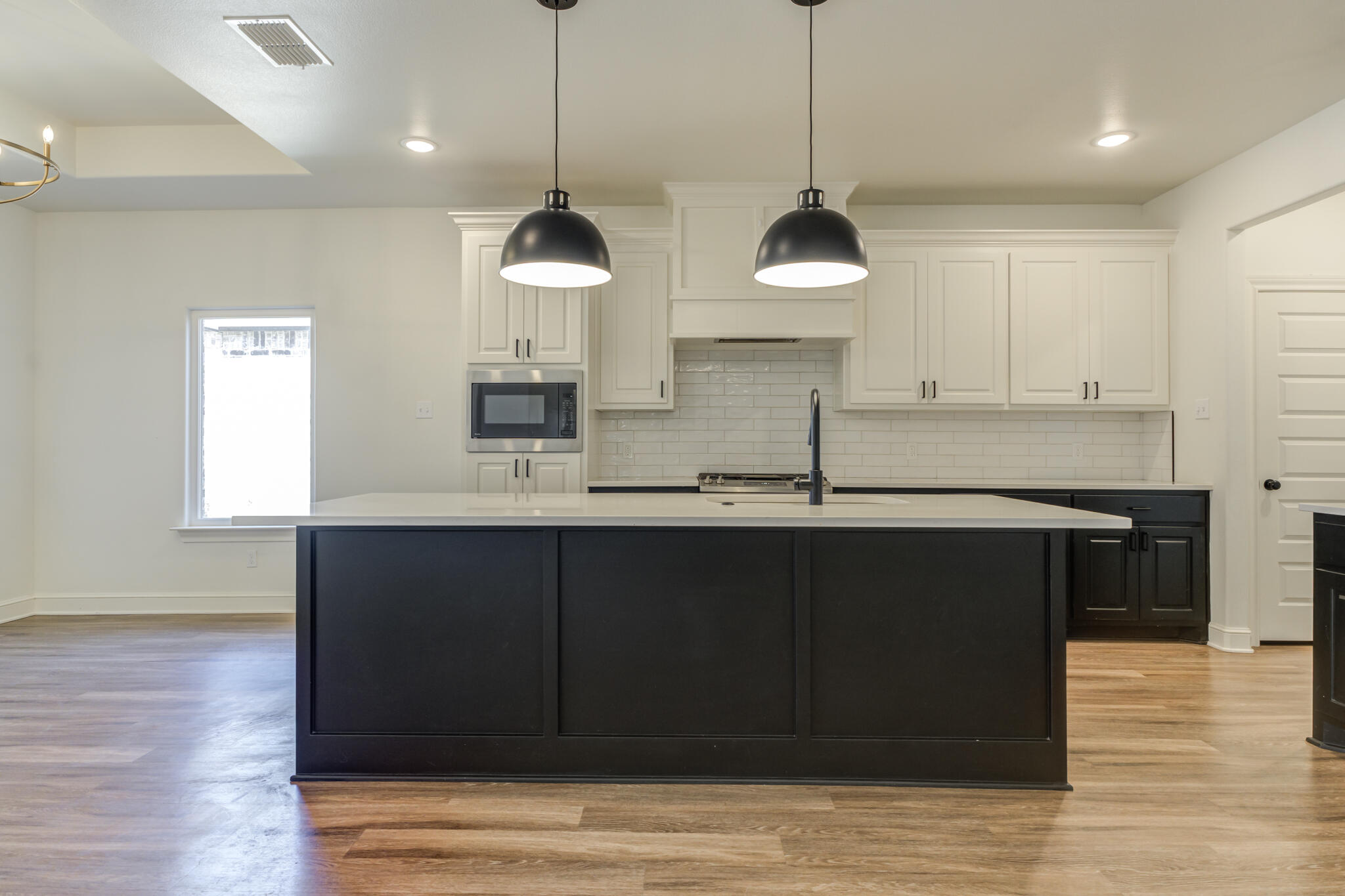 5720 119th Street Lubbock, TX 79424 - Photo 24 of 43 a kitchen with stainless steel appliances granite countertop a stove a sink and a wooden floor