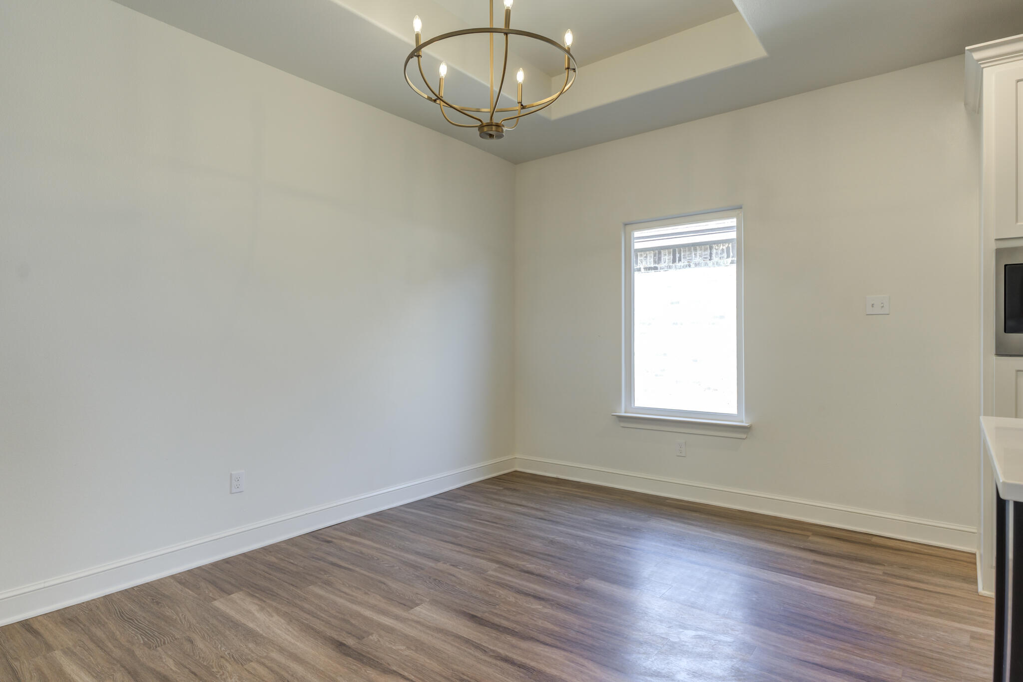 5720 119th Street Lubbock, TX 79424 - Photo 25 of 43 an empty room with wooden floor fan and window