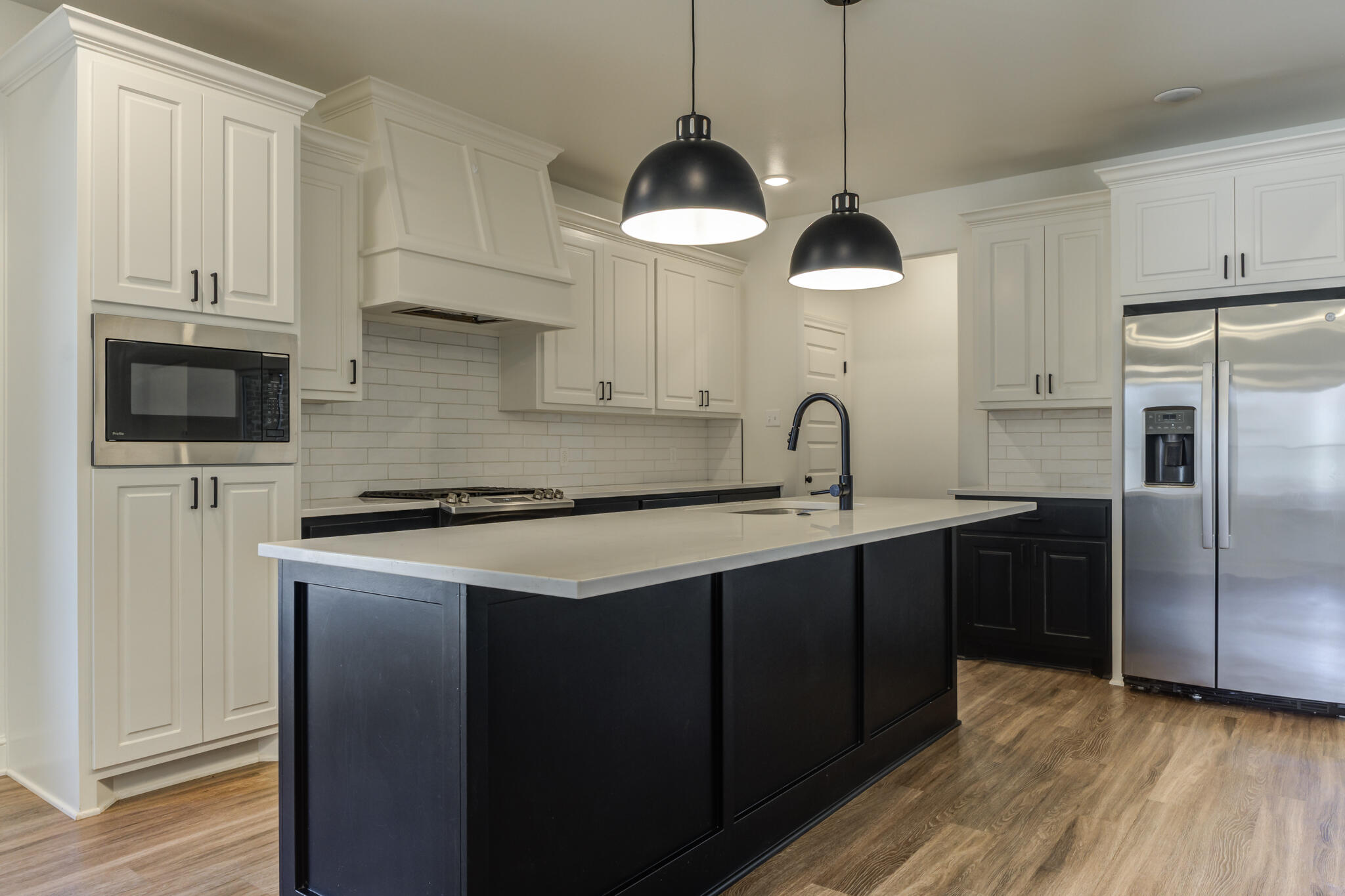 5720 119th Street Lubbock, TX 79424 - Photo 27 of 43 a kitchen with stainless steel appliances granite countertop a sink a microwave a refrigerator and white cabinets