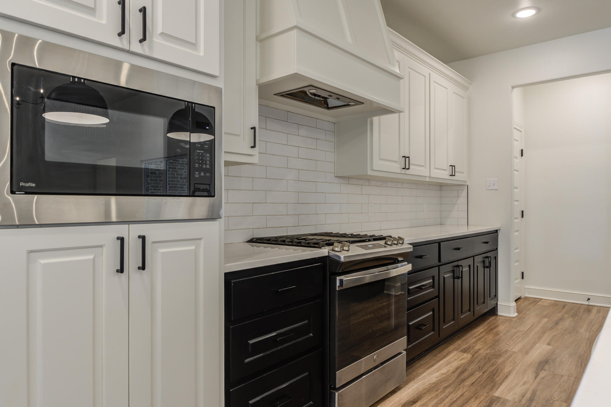5720 119th Street Lubbock, TX 79424 - Photo 28 of 43 a kitchen with stainless steel appliances a stove microwave and cabinets