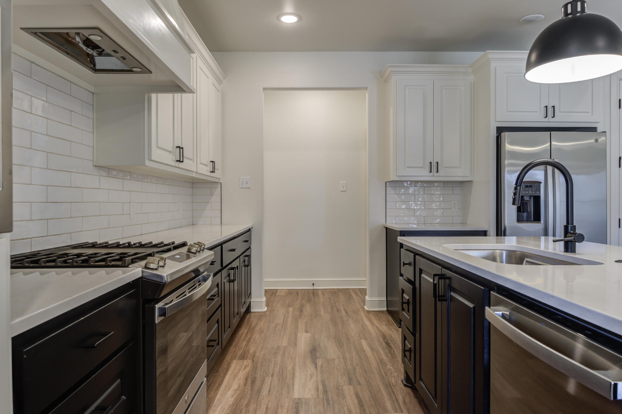 5720 119th Street Lubbock, TX 79424 - Photo 29 of 43 a kitchen with a sink stove and cabinets