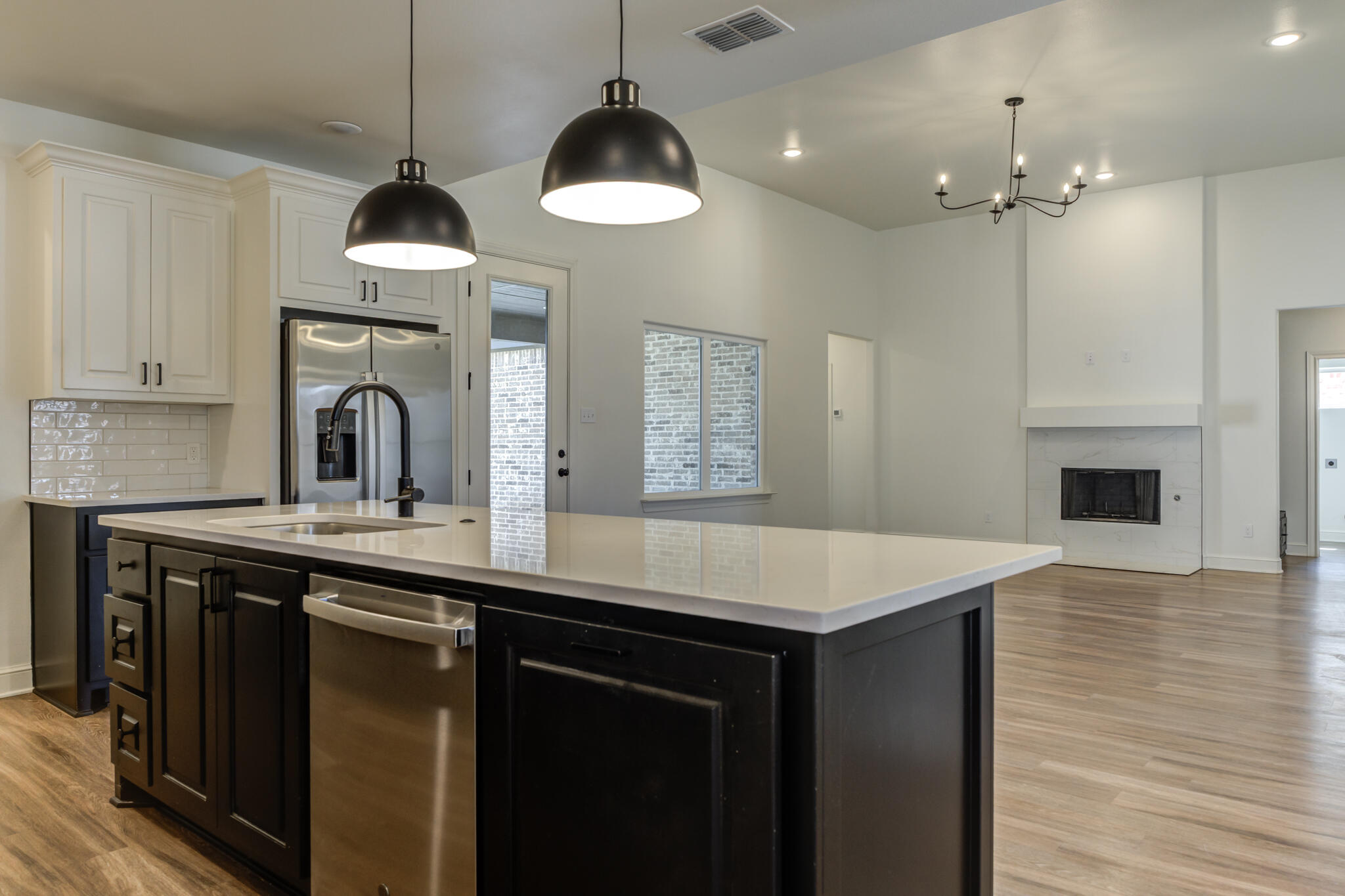 5720 119th Street Lubbock, TX 79424 - Photo 30 of 43 a kitchen with stainless steel appliances a stove a sink and a wooden floor