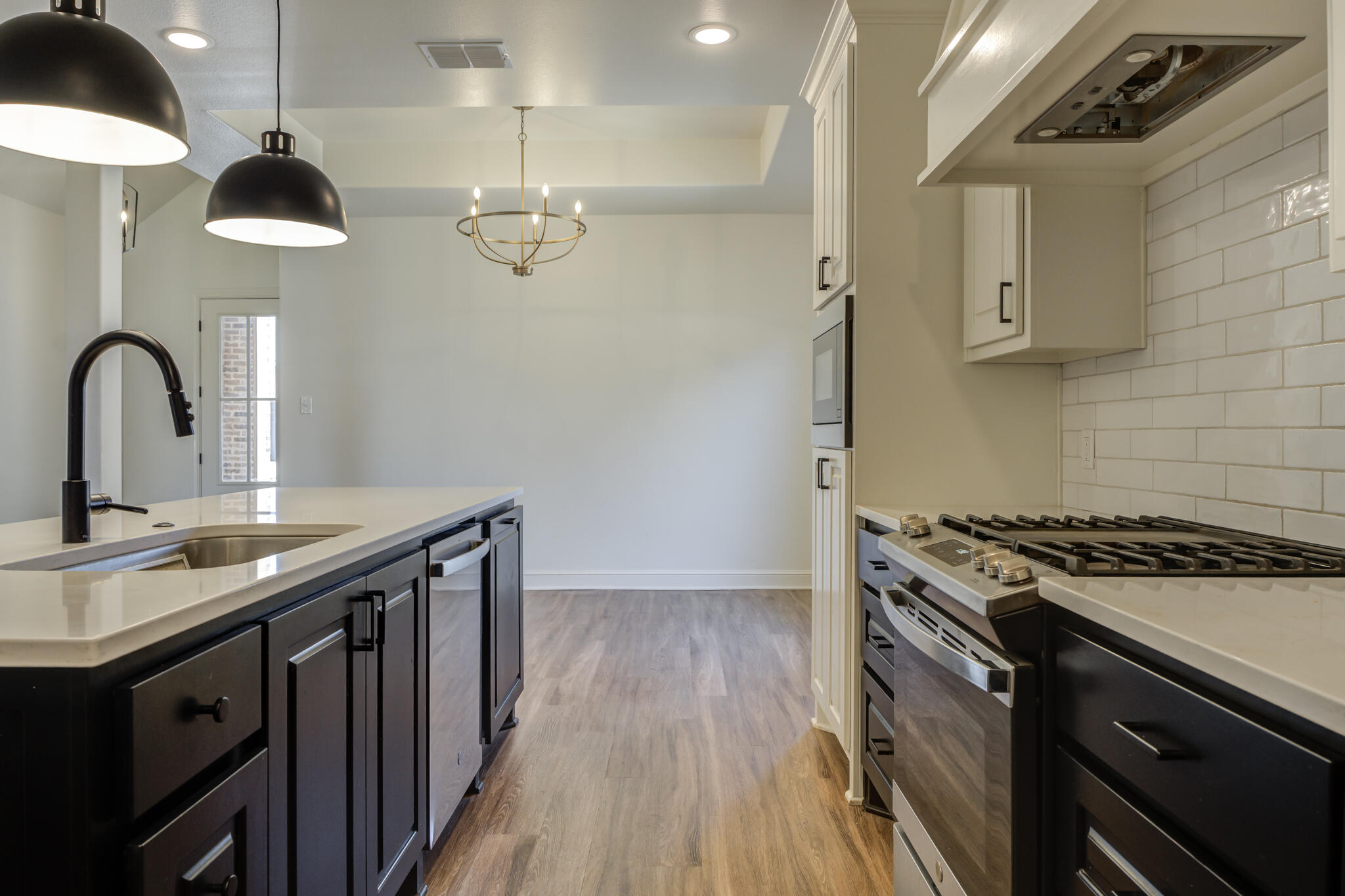 5720 119th Street Lubbock, TX 79424 - Photo 32 of 43 a kitchen with stainless steel appliances a sink a stove and cabinets