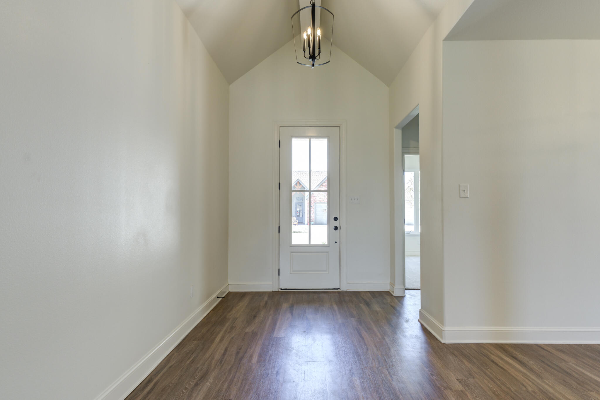5720 119th Street Lubbock, TX 79424 - Photo 4 of 43 an empty room with wooden floor and windows