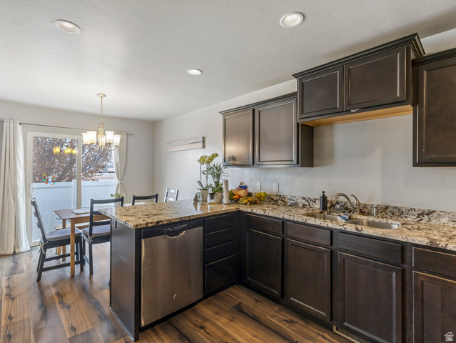 12214 Sunpark Lane Draper, UT 84020 - Photo 8 of 24 Kitchen with a peninsula, dark wood finish cabinetry, dark wood-type flooring, and stainless steel dishwasher