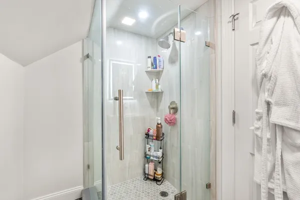 a bathroom with a shower and a sink