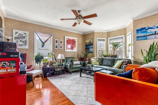 a living room with furniture kitchen view and a window