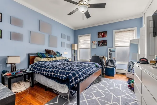 a bedroom with a bed and dresser with mirror