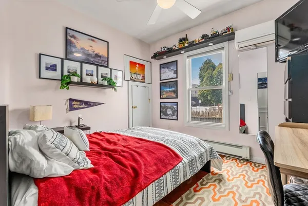 a bedroom with bed and a window
