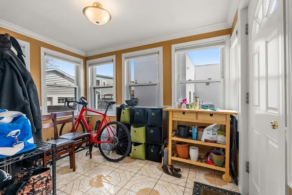 a living room with furniture a flat screen tv and a window