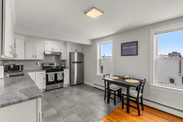 a kitchen with stainless steel appliances kitchen island granite countertop a sink and cabinets