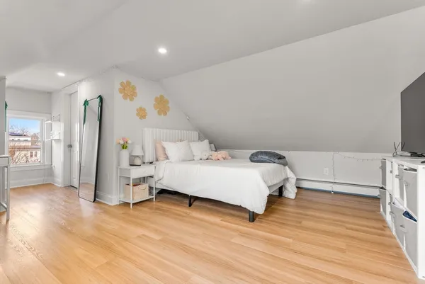 a bedroom with a bed and a flat screen tv