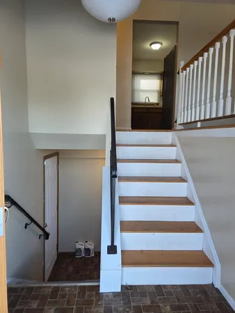 a view of staircase with white walls and a window