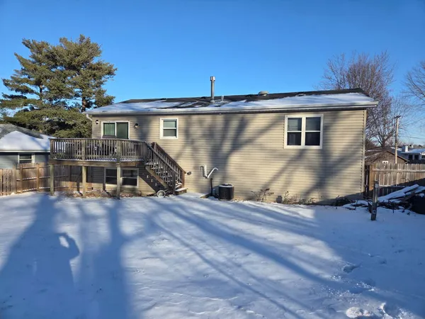 a view of a house with wooden deck