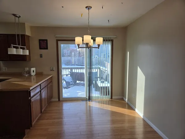 a open kitchen with a sink and wooden floor